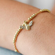 Close Up of Model Wearing Estella Bartlett Crystal Bee Bracelet in Gold