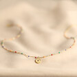 Estella Bartlett Crystal Rainbow Pendant Necklace in Gold on Natural Coloured Fabric Full Length