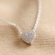 Close Up of Pendant on Estella Bartlett Pavé Heart Pendant Necklace in Silver on Natural Coloured Fabric