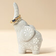 Grey Ceramic Elephant Ring Holder with Gold Rings on Neutral Table