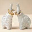 Ceramic Elephant Ring Holders with gold rings on neutral backdrop