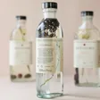 Fikkerts Fruits of Nature Lavender Bath Essence Turned to the Side with Other Fragrances in Background