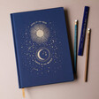 Front Cover of Designworks Ink Live By The Sun Jumbo Notebook with Celestial Pencils