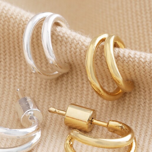 Double Illusion Huggie Hoop Earrings in Silver and Gold on Beige Fabric