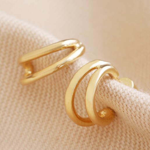Double Illusion Huggie Hoop Earrings in Gold on Beige Fabric