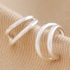 Double Illusion Huggie Hoop Earrings in Silver on Beige Fabric