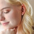 Blonde Model Wearing Tiny Crystal Heart Stud Earrings in Silver