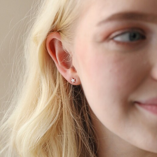 Tiny Star Stud Earrings in Silver on Model