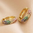 Wide Rainbow Crystal Hoop Earrings in Gold on Folded Neutral Fabric