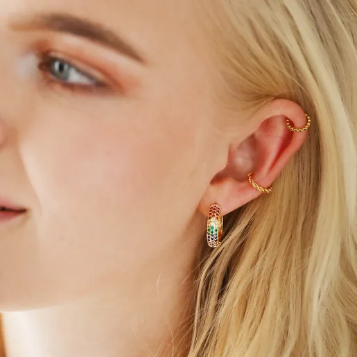 Blonde Model Wearing Wide Rainbow Crystal Hoop Earrings in Gold with Other Earrings