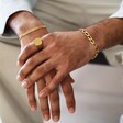 Model Wearing Men's Brushed Gold Stainless Steel Signet Ring With Other Gold Jewellery