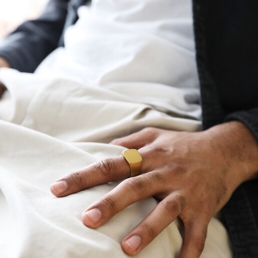 Model Wearing Men's Brushed Gold Stainless Steel Signet Ring With Hand on Lap