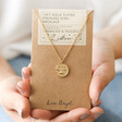 Gold Stainless Steel Libra Pendant Necklace on Card held by Model