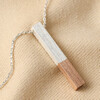 Rose Gold Dipped Bar Pendant Necklace in Silver on Neutral Fabric