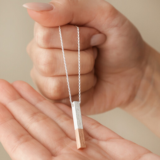 Model Holding Rose Gold Dipped Bar Pendant Necklace in Silver