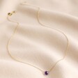 Semi-Precious Amethyst Stone Teardrop Pendant Necklace in Gold on Rippled Beige Fabric