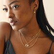 Model Wearing Stainless Steel Star Charm Necklace in Gold With Layered Necklaces
