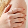 Model Wearing Twisted Rope Ring in Gold with Hand on Arm