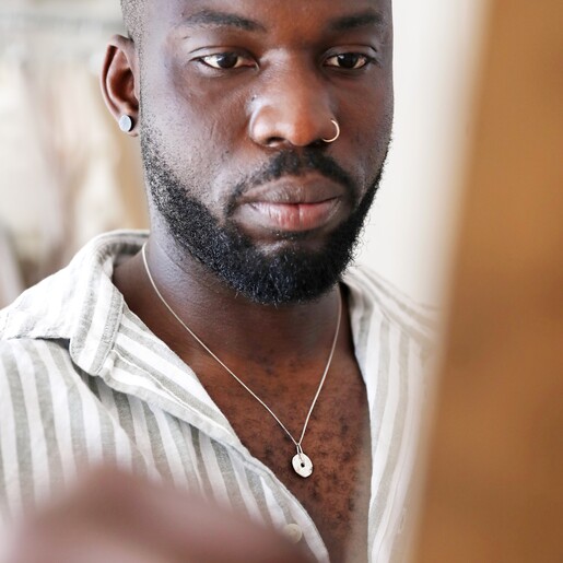Model Wearing Spinning Disc Pendant Necklace in Platinum