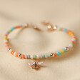 Colourful Beaded Bee Bracelet in Rose Gold on Beige Coloured Fabric