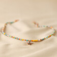 Colourful Beaded Bee Necklace in Rose Gold on Beige Fabric