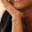 Close Up of Model Wearing Crystal Flower and Enamel Bee Bracelet in Gold