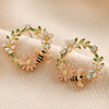 Crystal Flower and Enamel Bee Stud Earrings in Gold on Neutral Fabric