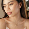 Model Wearing Crystal Flower and Enamel Bee Pendant Necklace in Gold Looking to the Side