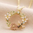 Crystal Flower and Enamel Bee Pendant Necklace in Gold on Beige Fabric