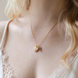 Model Wearing Shell Heart and Bee Charm Necklace in Gold