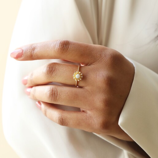 Model Wearing Opal and Enamel Floral Ring in Gold with Hand on Arm
