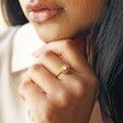 Model Wearing Opal and Enamel Floral Ring in Gold with Hand on Chin