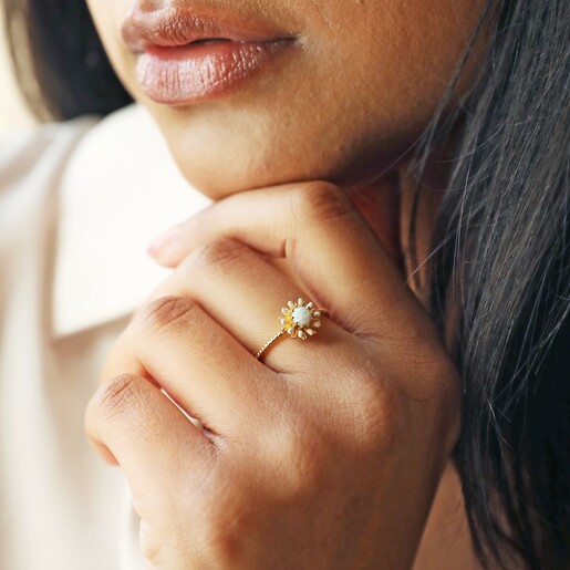 Model Wearing Opal and Enamel Floral Ring in Gold with Hand on Chin