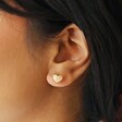 Model Wearing Shell Heart Stud Earrings in Gold