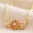 Triple Enamel Flower Pendant Necklace in Gold on Neutral Fabric