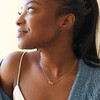 Model Wearing Triple Enamel Flower Pendant Necklace in Gold