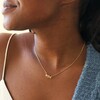 Close Up of Triple Enamel Flower Pendant Necklace in Gold on Model