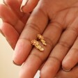Triple Enamel Flower Stud Earrings in Gold Held in Models Hands