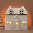 Ceramic House Wax Melt Burner in Dim Room with Warm Lighting