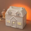 Over Shot of Ceramic House Wax Melt Burner with Warm Lighting with Windows Glowing