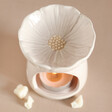 Top of Pink Blossom Ceramic Wax Melt Burner Showing Flower with Lit Tealight Inside and Wax Melt Surrounding