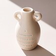 Small Ceramic Daughter Bud Vase in Shadow against Neutral Background