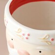 Close Up of Small Ceramic Father Christmas Planter on Neutral Background