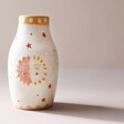 Sun and Moon Face Ceramic Posy Vase Placed on Neutral Background With Shadow