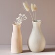 Peach Textured Ceramic Bud Vase with White Vase against Neutral Background