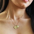 Model Wearing All Gold Personalised Family Constellation Disc Charm Necklace With Two Small Charms and One Large Charm