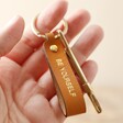 Model Holding Personalised Leather Strap Keyring Attached to Key