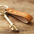 Personalised Leather Strap Keyring Attached to Key on Wooden Surface