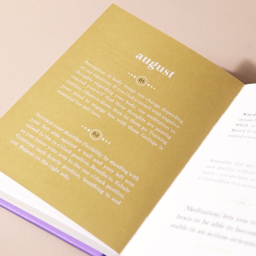 Gold Inside Page of 365 Days of Mindful Meditations Book with Neutral Backdrop