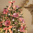 Rounded Pink Velvet Flower Clips on Christmas Tree with Lights and Ribbons